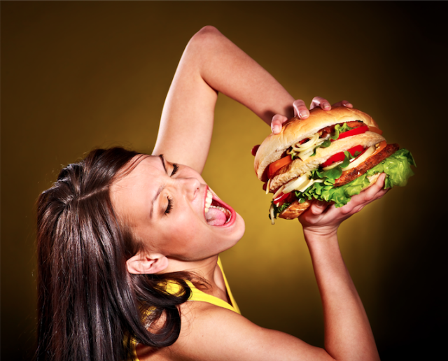 girl eating a big hamburger